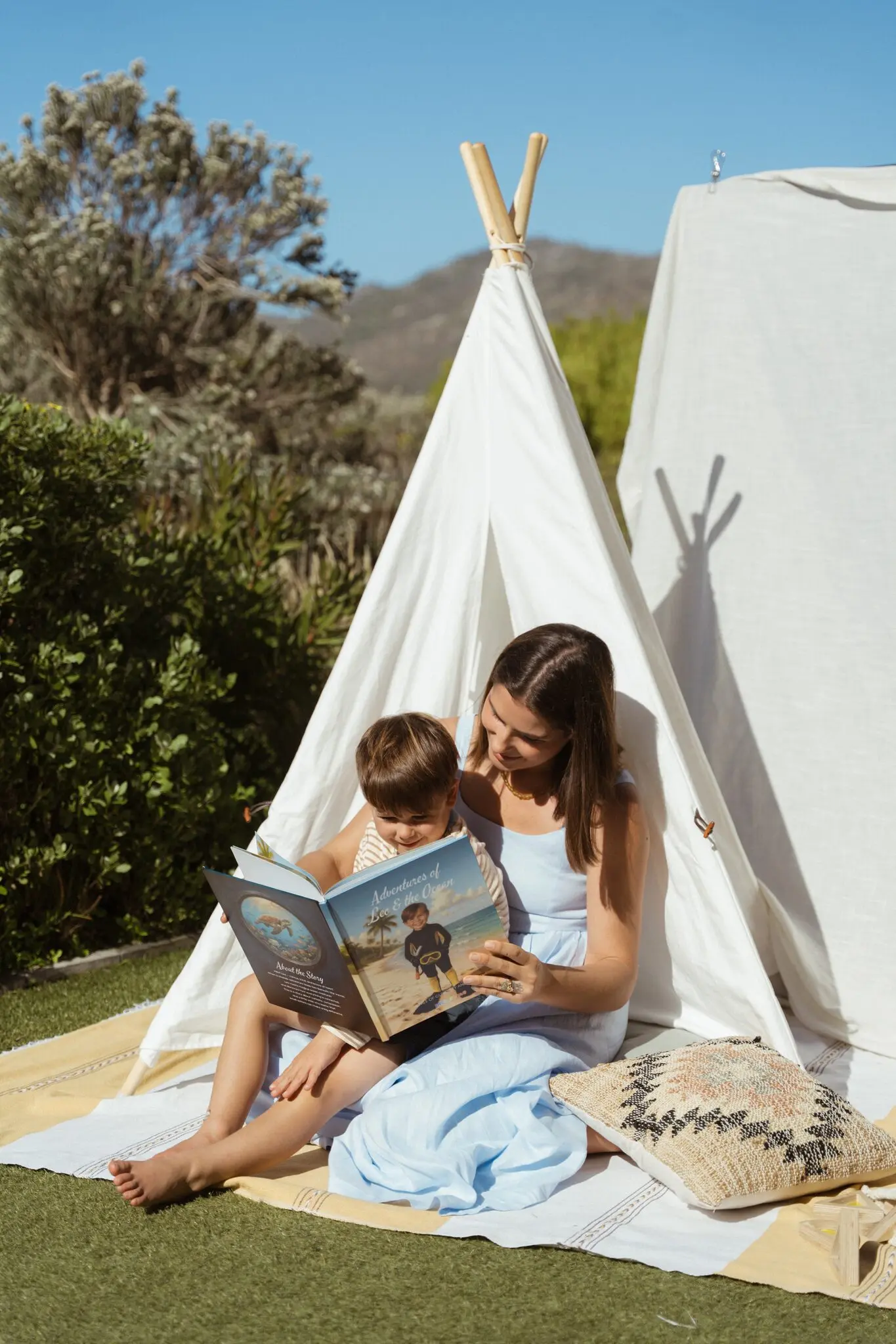 A mom reading the ocean story to her son