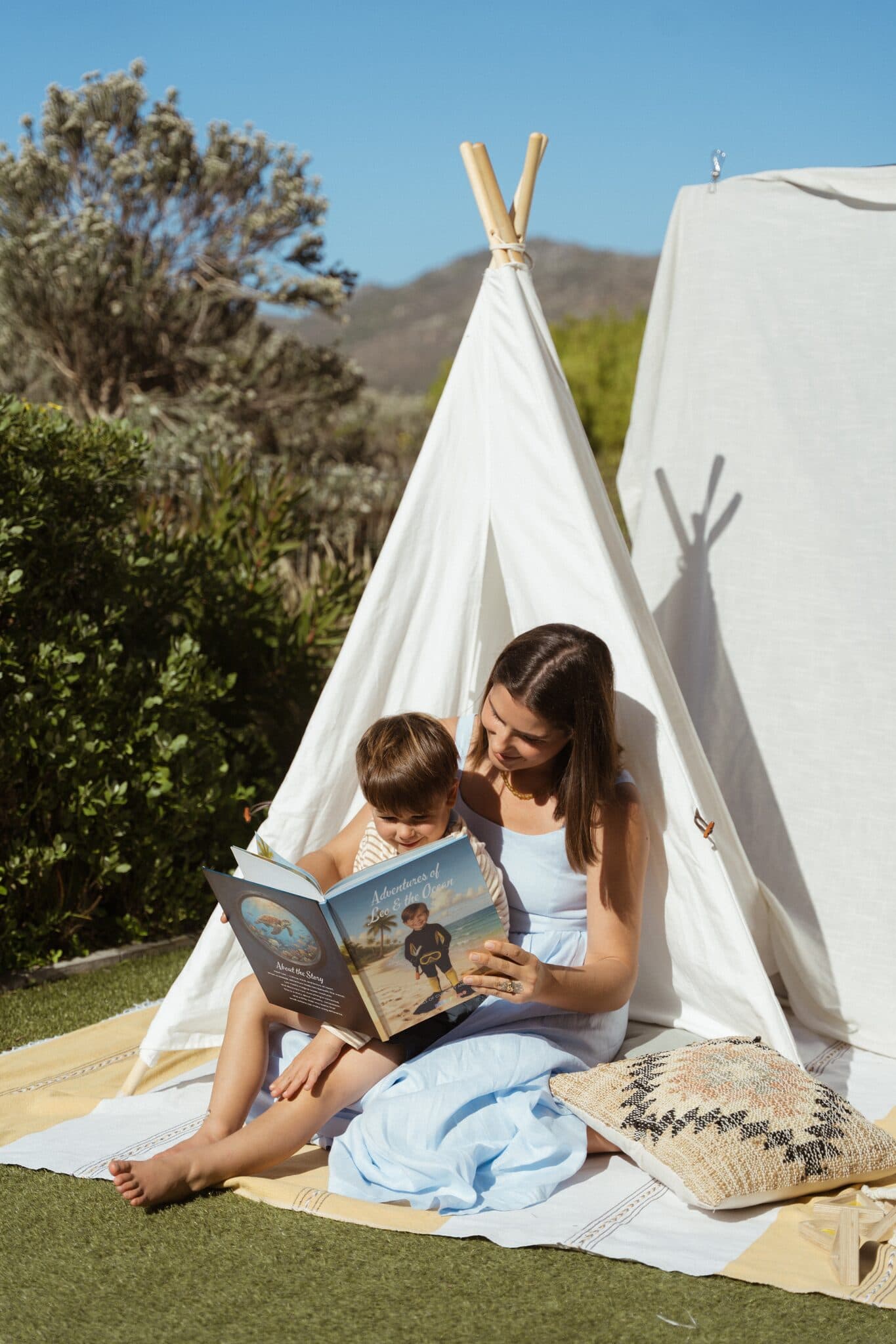 A mom reading the ocean story to her son