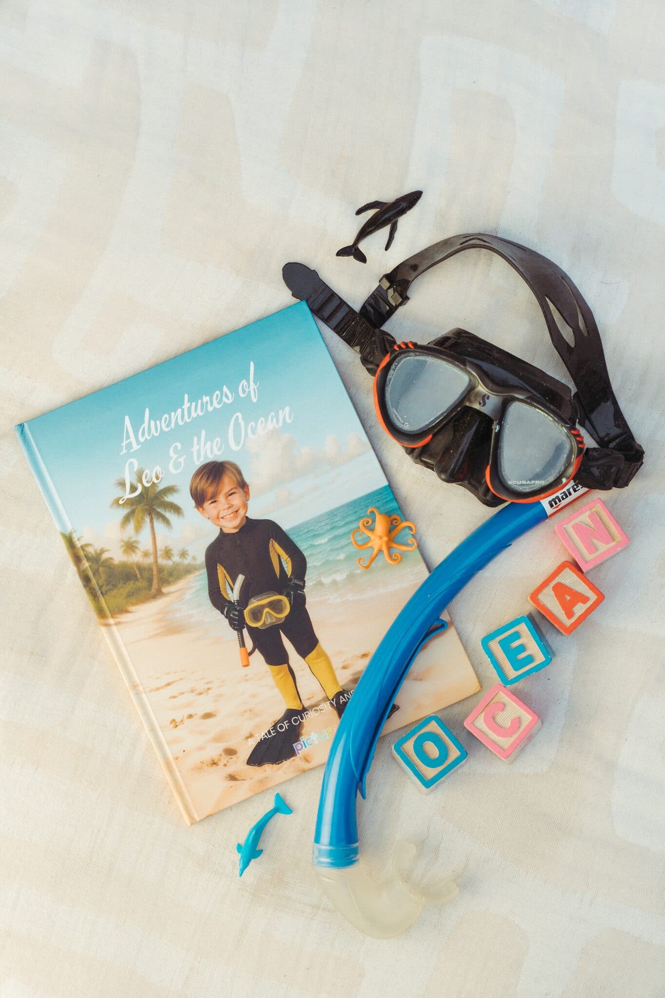 The ocean hardcover with a snorkel, mask and toy sea creatures