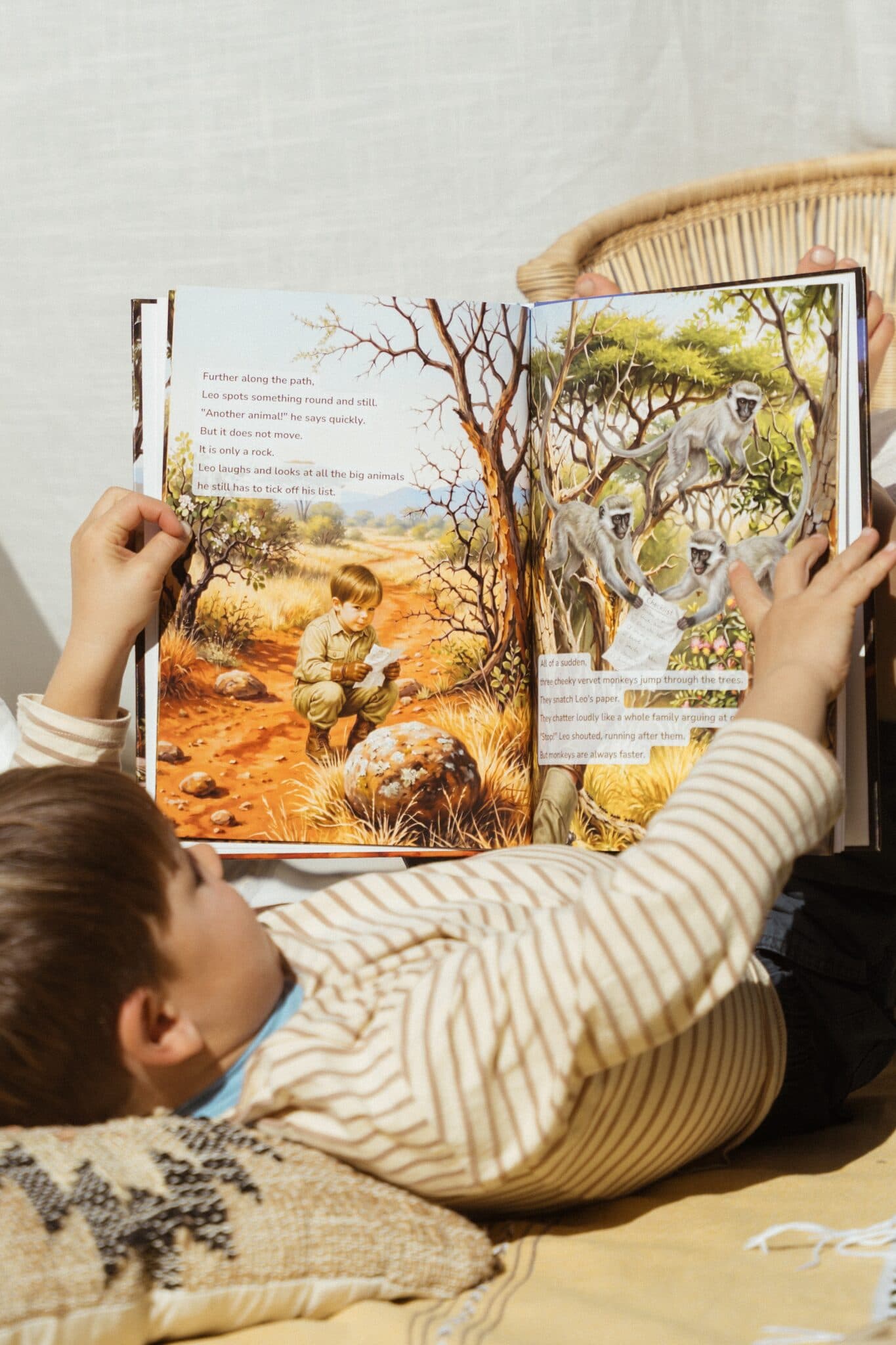 An open spread inside the safari story — the child illustrated among vervet monkeys