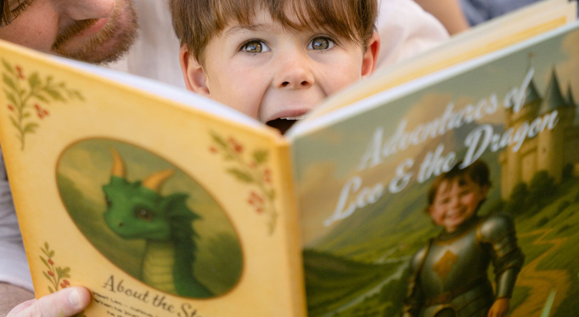 A boy reading his Picture Me storybook, his illustrated likeness on the cover facing the camera